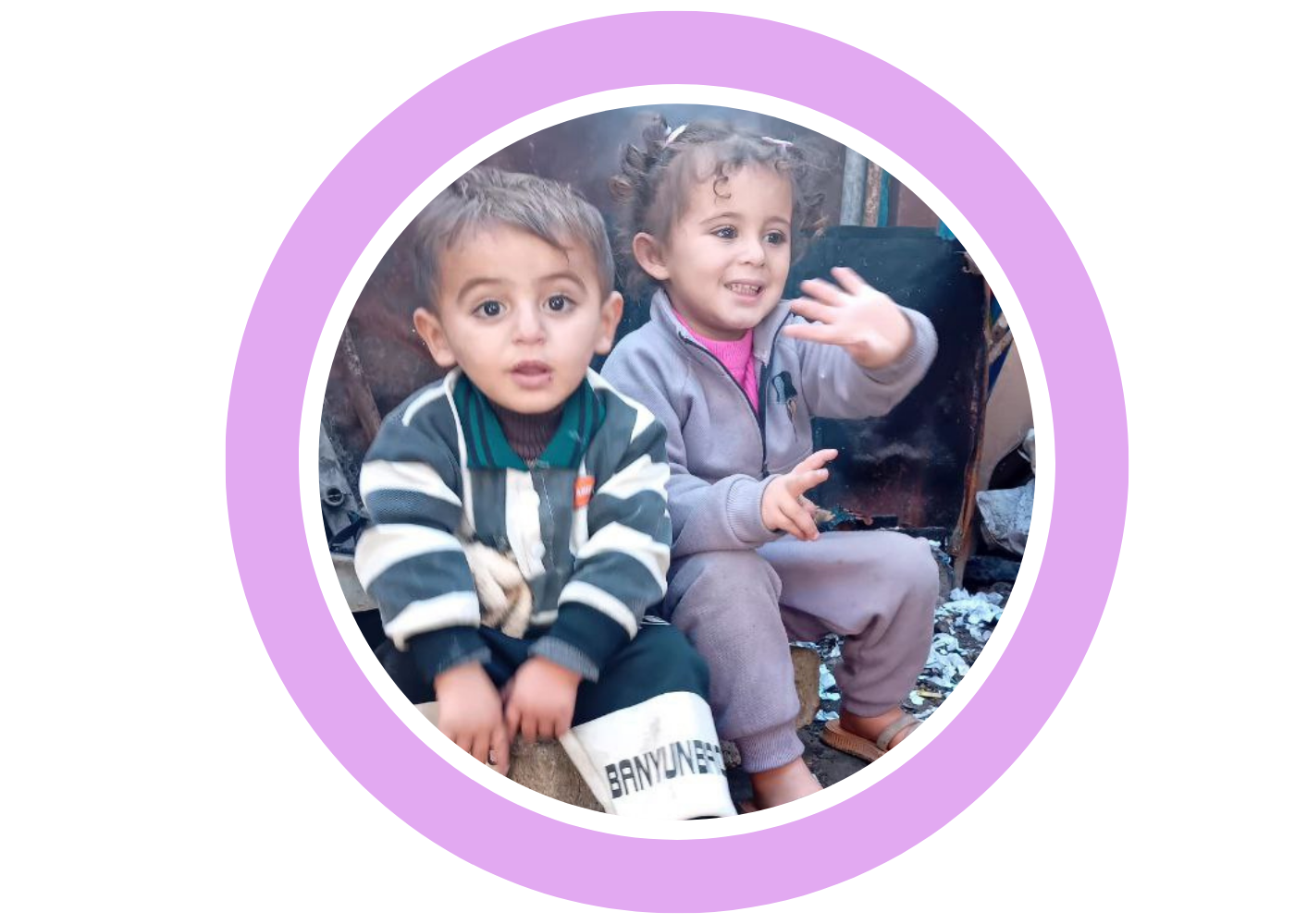 Two young children waving